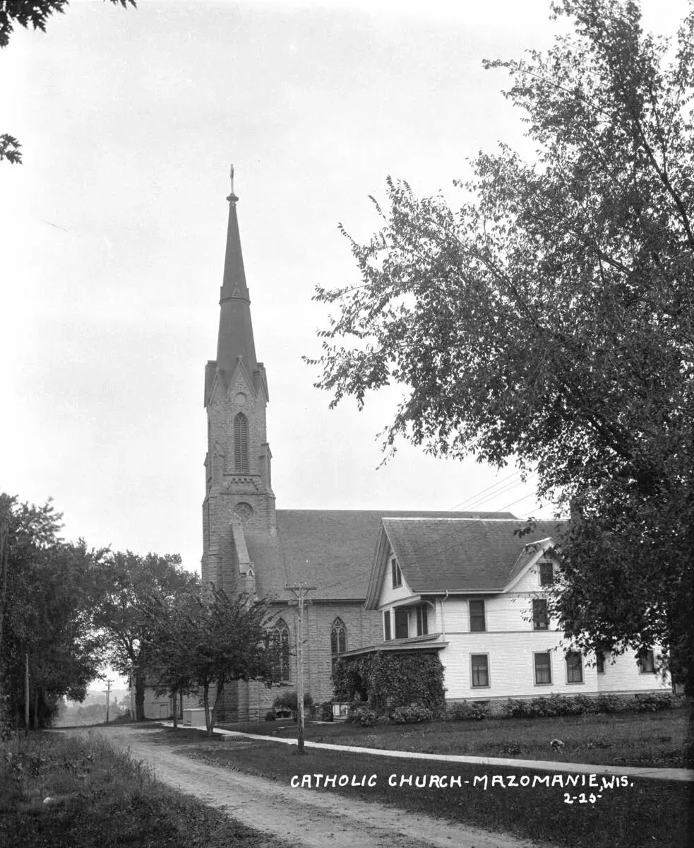St. Barnabas’s stone church with a tall spire, and the rectory beside it, in 1925